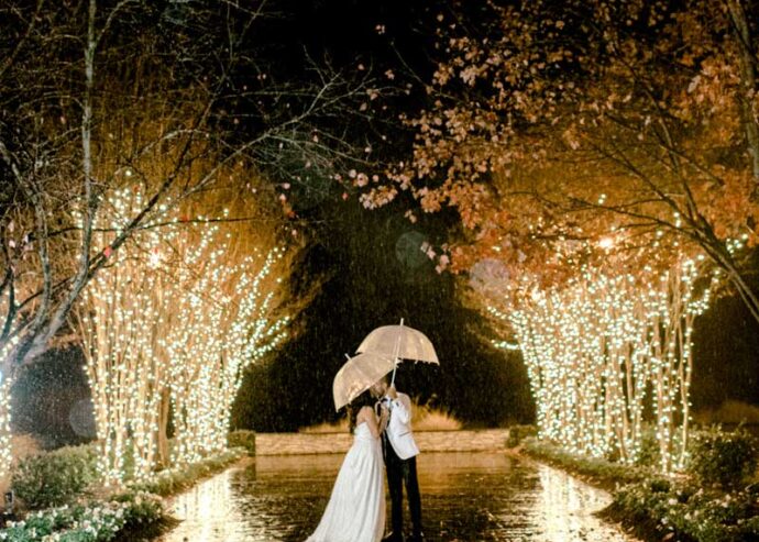 Night portrait of bride and groom on terrace
