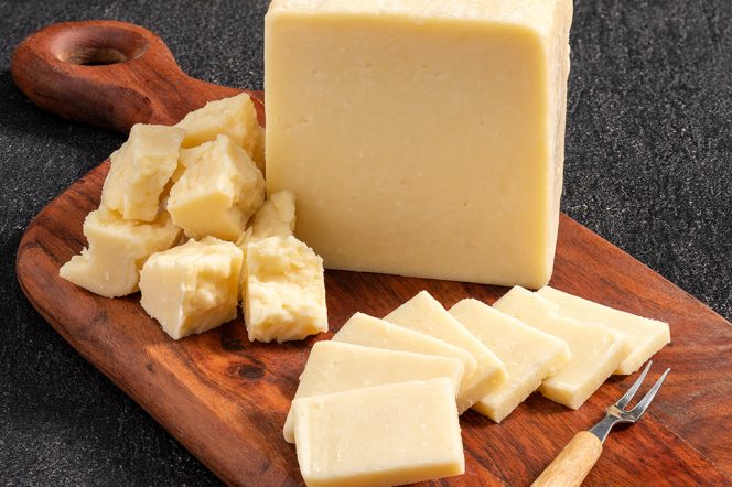 Assortment of Mountain Valley sharp cheddar cheese on a wooden board