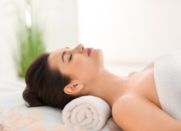 Woman relaxing at a luxury spa with towel and aromatherapy, Lansdowne Resort wellness experience