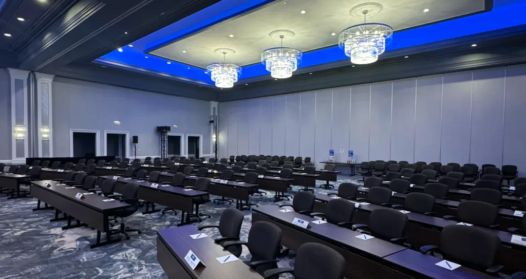 An image of a large boardroom at Lansdowne Resort, prepared for an incoming meeting with pens, paper and refreshments in the back, accommodated to support trends in the event industry.