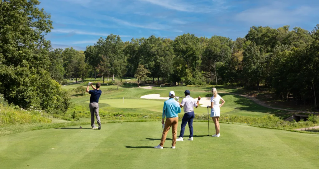 A group of golfers, golfing together at a course at Lansdowne resort during a sunny day.