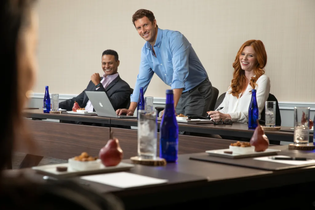 A corporate team that used AI for event planning, working seamlessly together in one of Lansdowne Resort's state of the art meeting rooms.